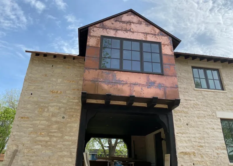 Copper metal panel facade on a stone building for Roof Repair in Mims
